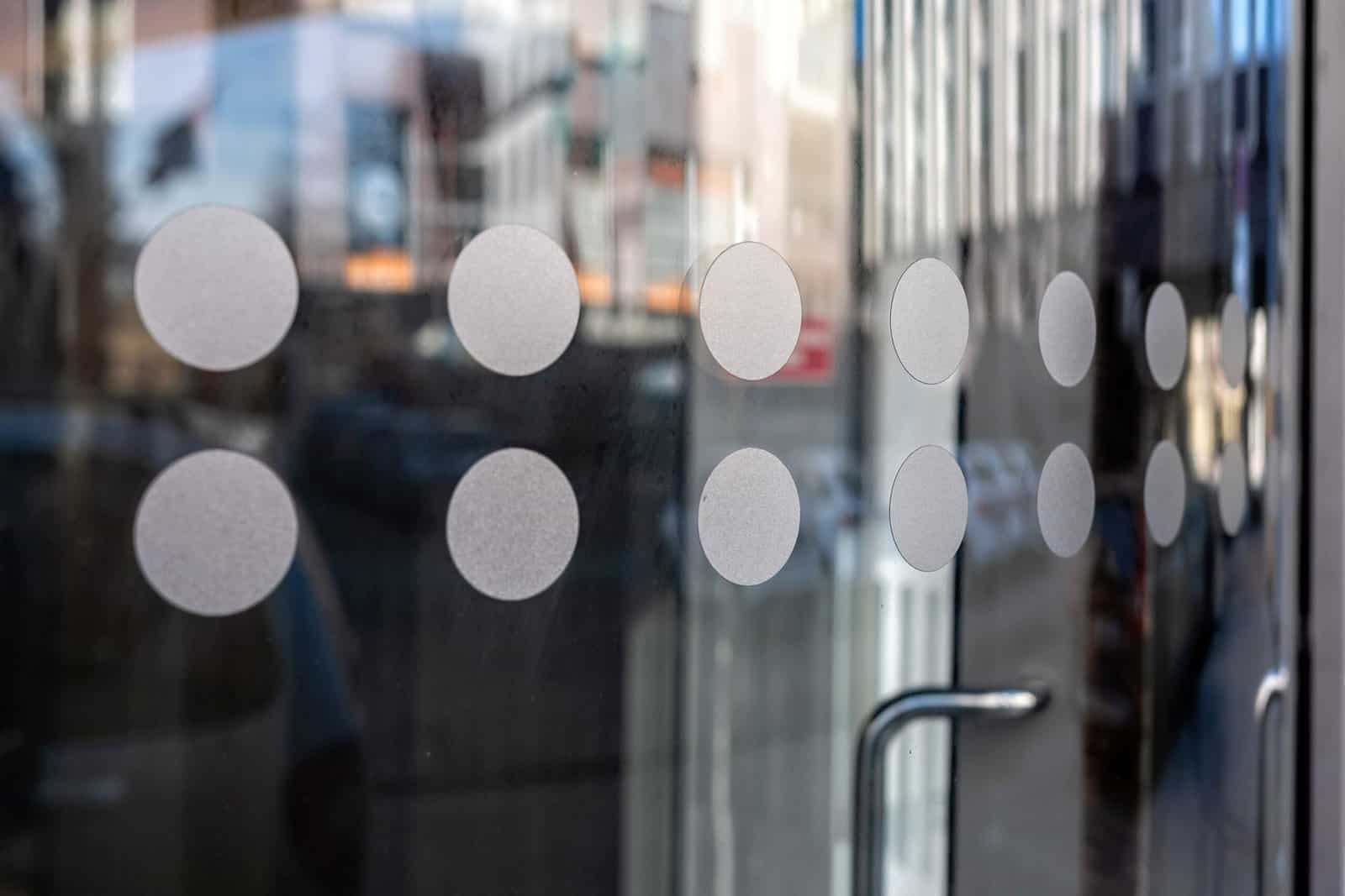 close-up of modern secured glass door fragment at corporate business building. - Image Decorative frosted film for Trafford Office